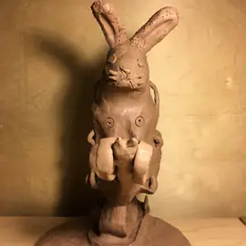 Front view of the brown Robo Rabbit sculpture with long ears and textured circles